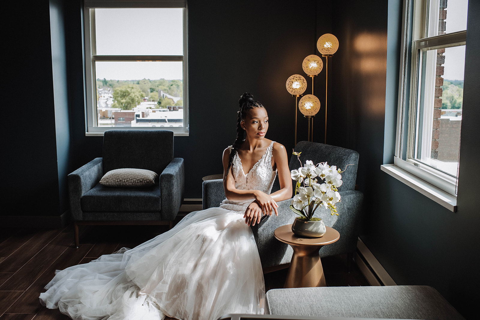 a woman in a white dress sitting in a chair