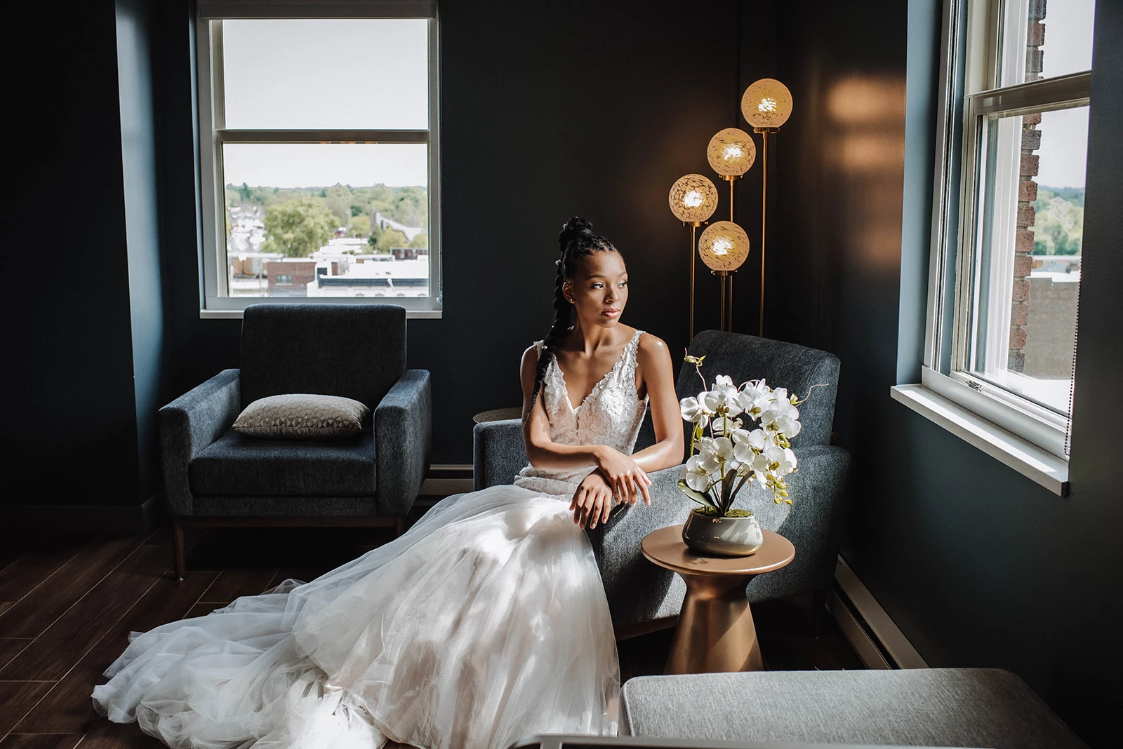 a woman in a white dress sitting in a chair