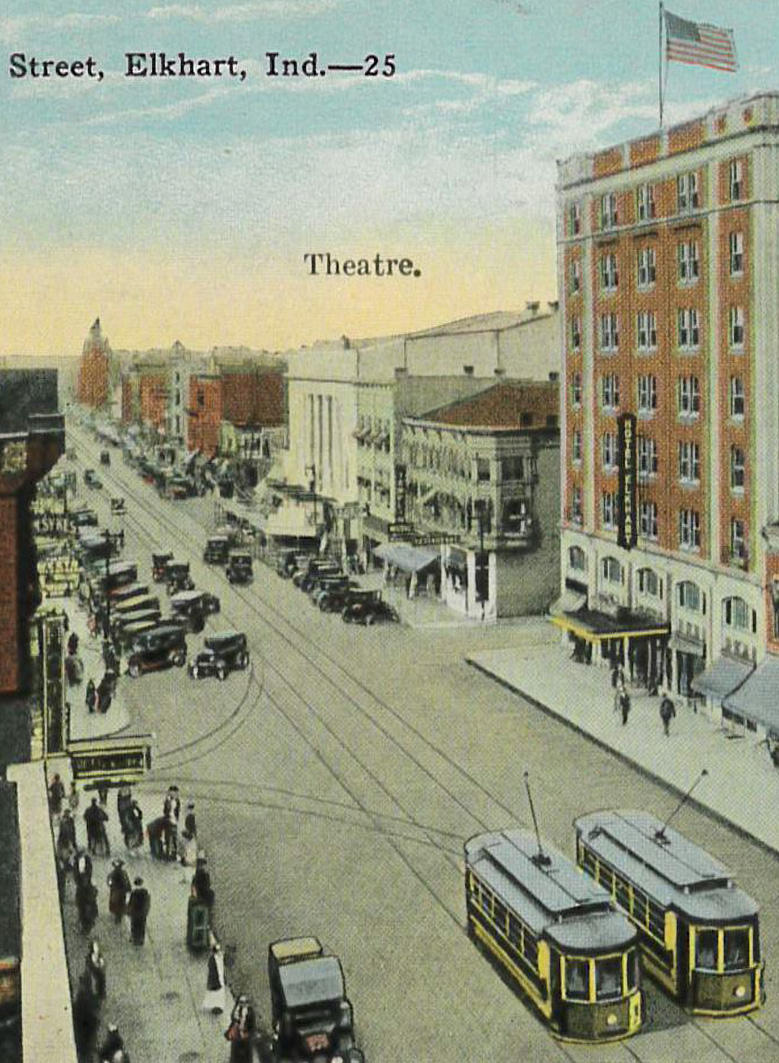 an old photo of a street with cars and people