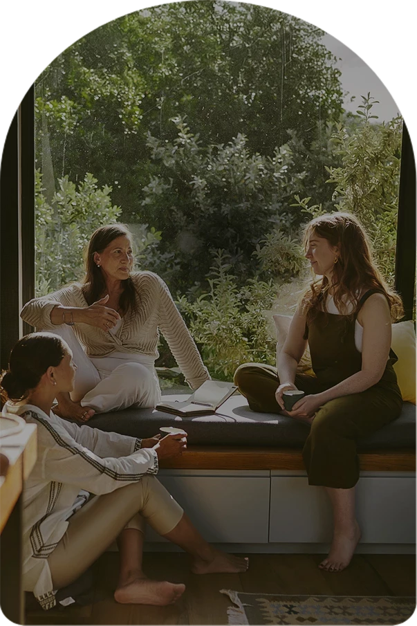 a group of women sitting on a window sill