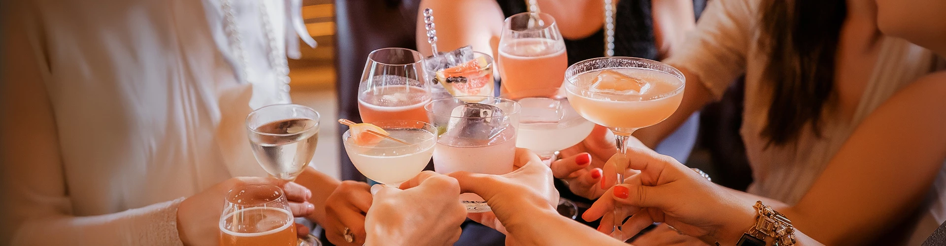 a group of people holding glasses of drinks