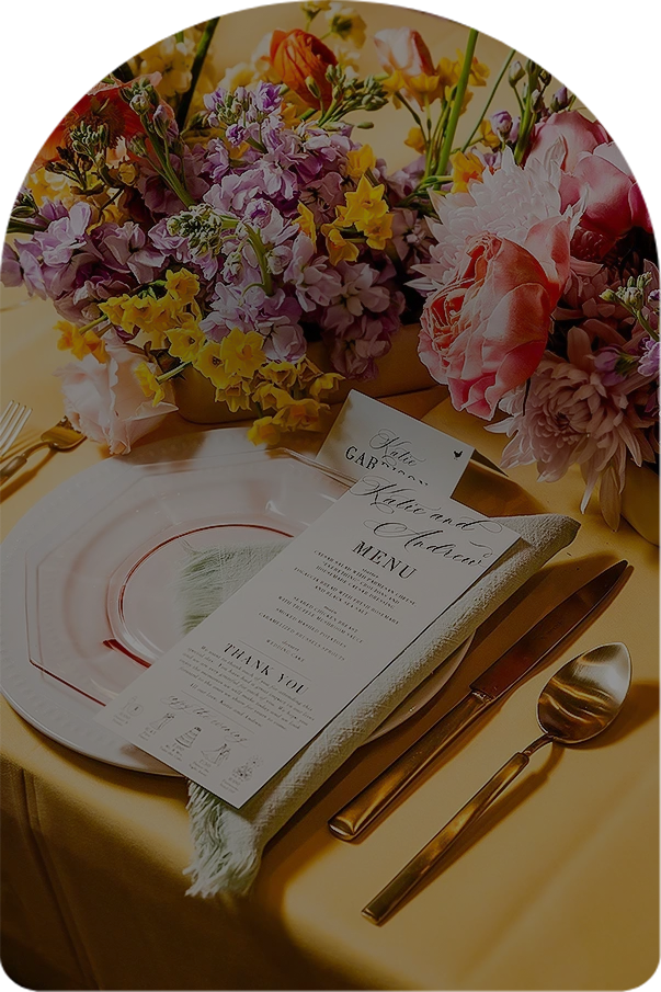 a table with flowers and a menu