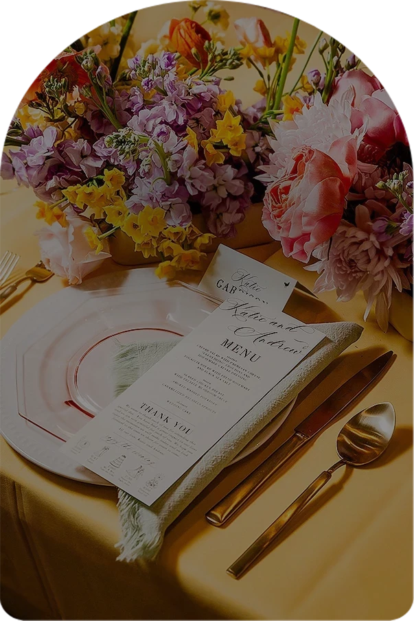 a table with flowers and a menu