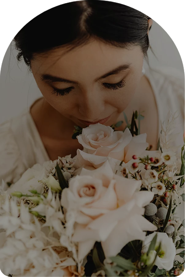 a woman smelling a bouquet of flowers