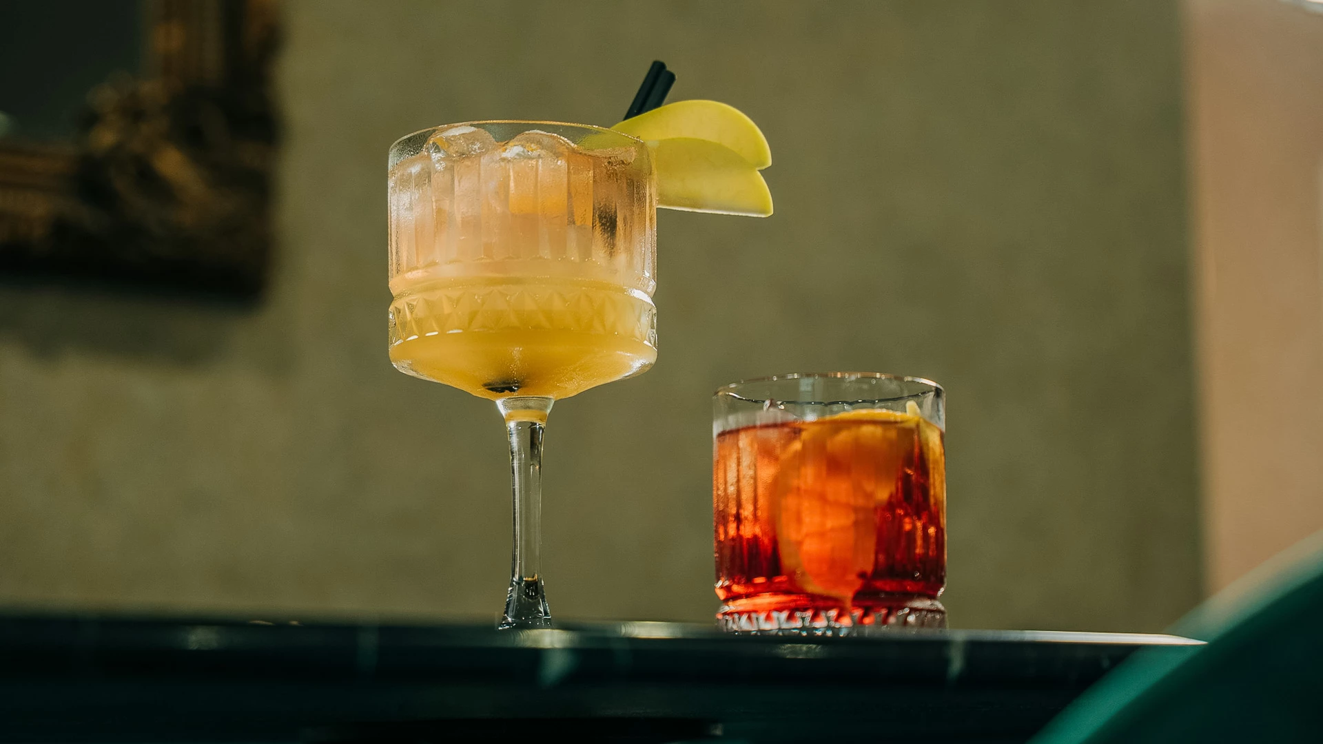 a glass of liquid with fruit on top of it