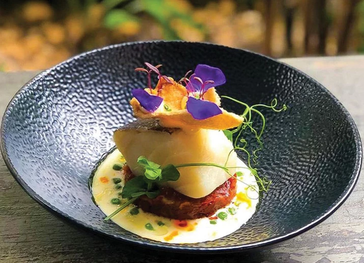 a plate of food with flowers on top