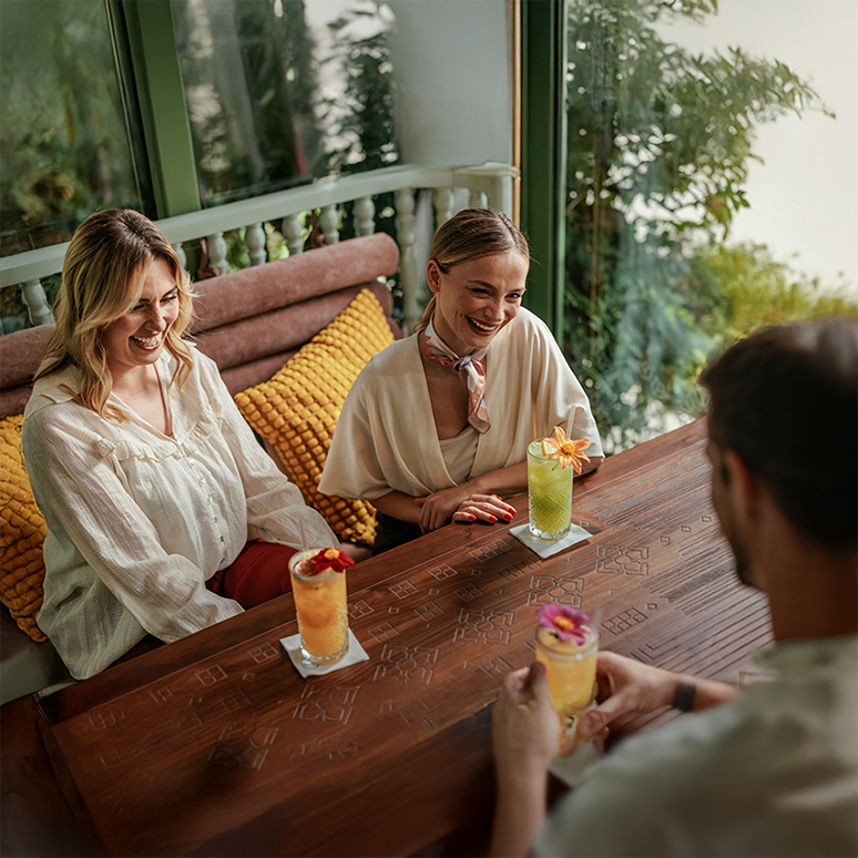 a group of people sitting at a table with drinks