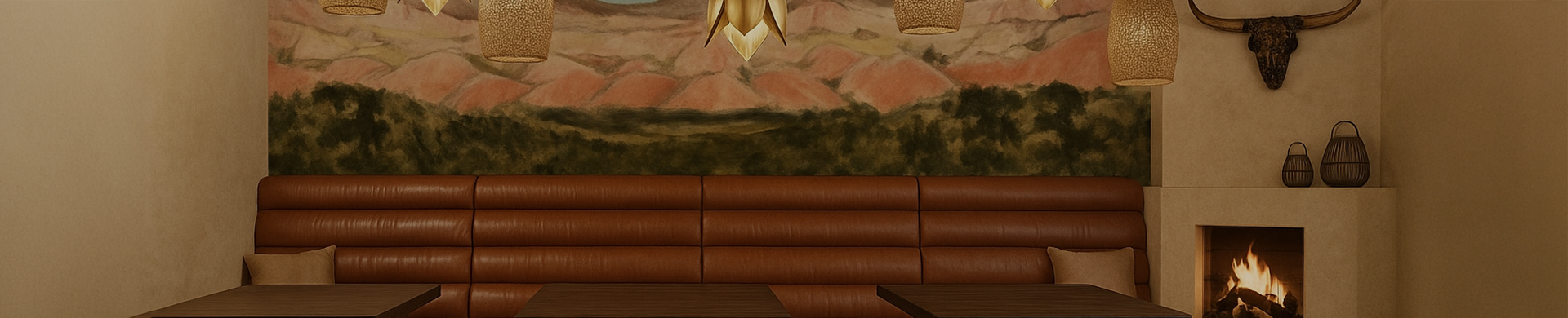 a brown couch with a lamp from the ceiling