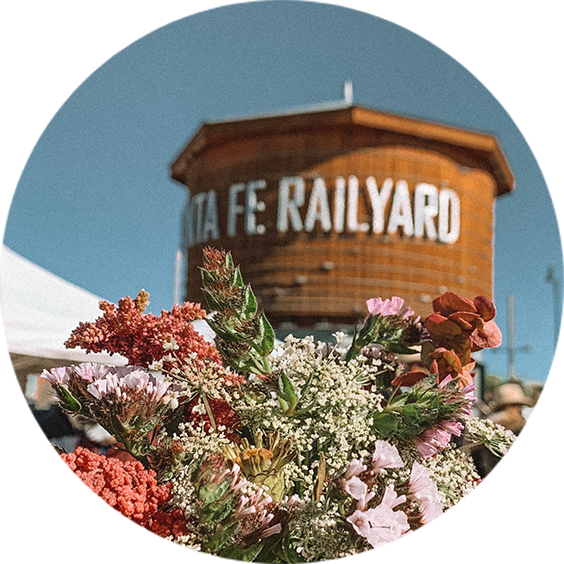 a bouquet of flowers in front of a round building