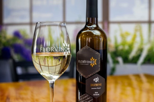 a bottle of wine next to a glass