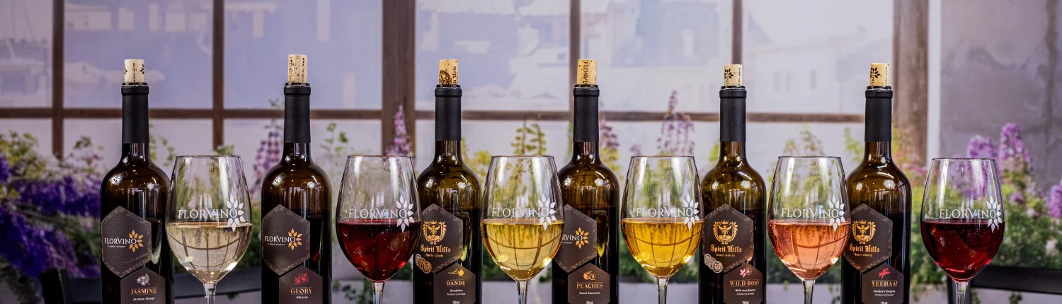 a group of wine bottles and glasses on a table
