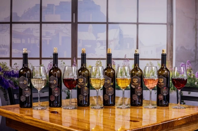 a group of wine bottles and glasses on a table