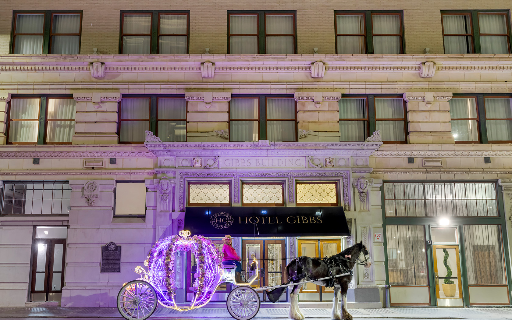 a horse carriage in front of a building