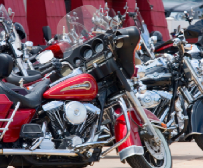 motorcycles lined up along road