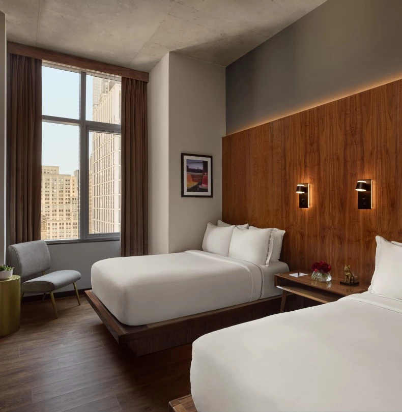 a room with two beds and a chair 