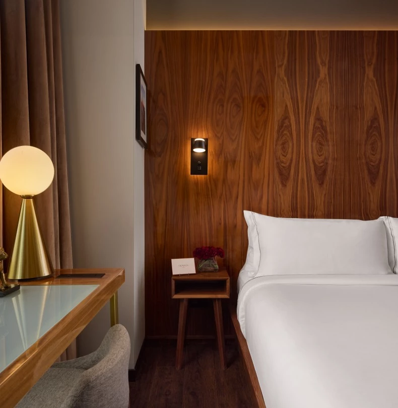 a bed with a table and lamp 