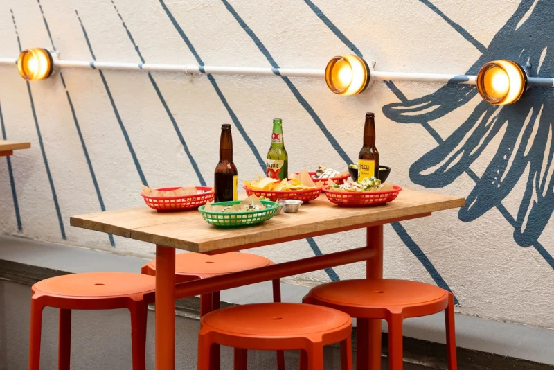 a table with food and beer bottles on it