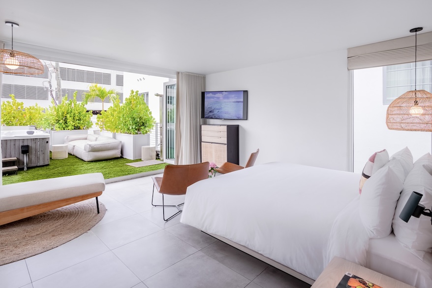a bedroom with a large bed and a television