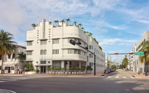 a white building with plants on top of it