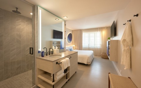 a bathroom with a bed and a mirror