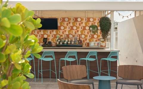 a bar with blue chairs and a wallpaper