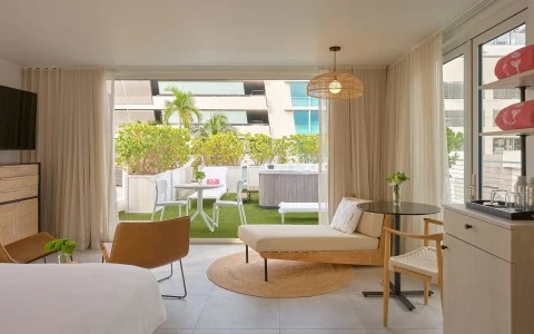 a room with a bed and chairs and a table