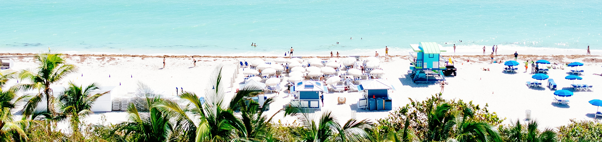 a beach with umbrellas and people on it