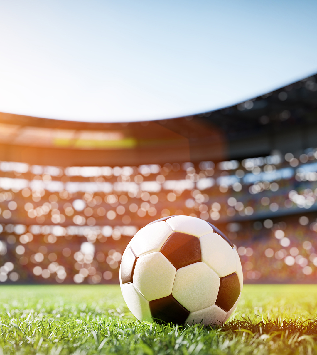 a football ball on grass in a stadium