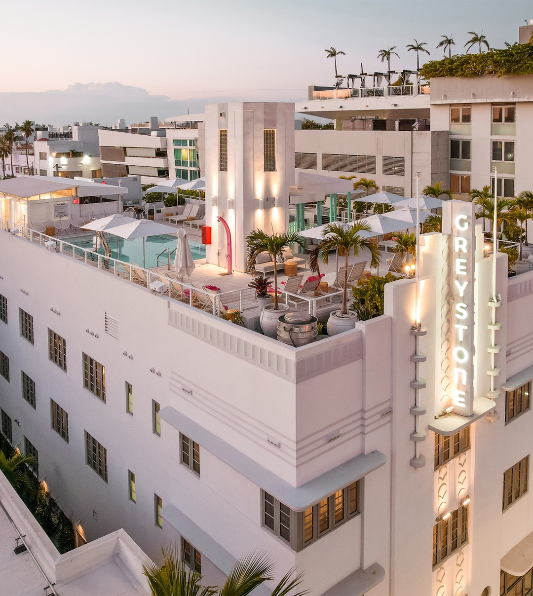 a building with a pool and a sign on top of it