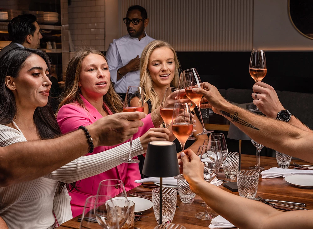 a group of women holding wine glasses