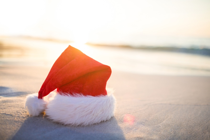 a santa hat on a beach