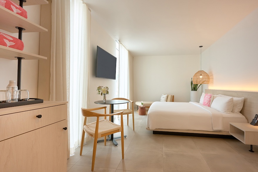 a room with a bed and a table and chairs