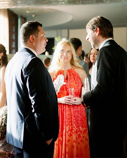 View of two men and a woman on an elegant event