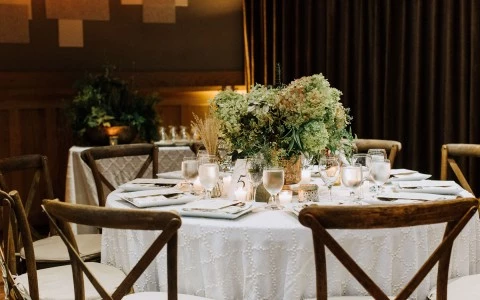 round banquet table set for a wedding with a center piece