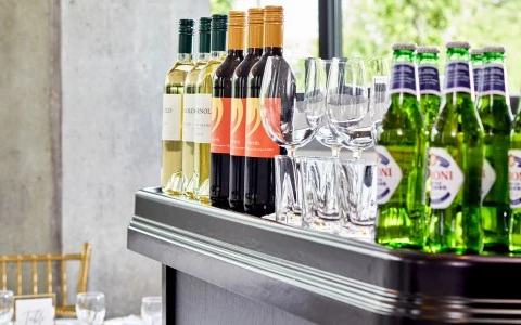 a row of bottles and glasses on a bar