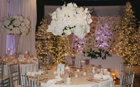 a room with tables and chairs with flowers on them