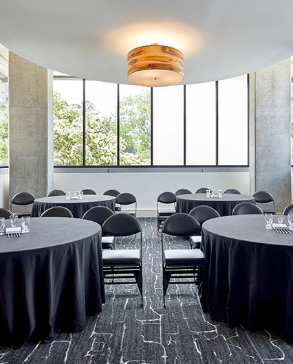 a room with round tables and chairs