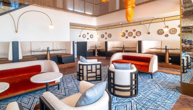 a room with a large area with chairs and tables