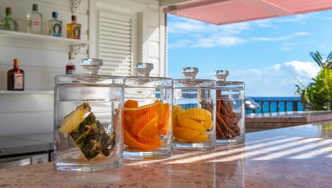 a group of glass jars with fruit in them