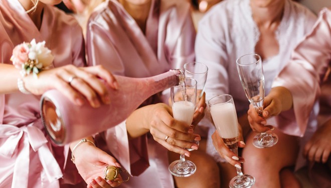 a group of women pouring champagne into glasses