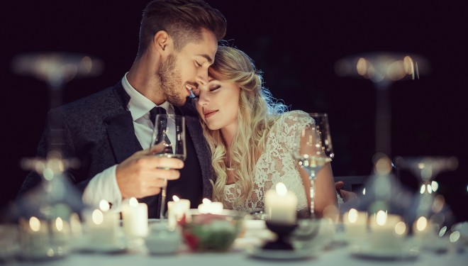 a man and woman holding wine glasses