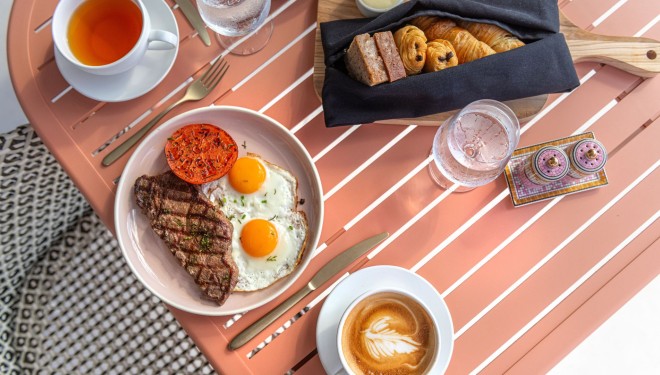a plate of food and coffee on a table