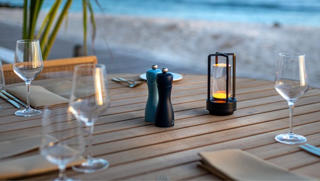 a table with a candle and salt shaker on it