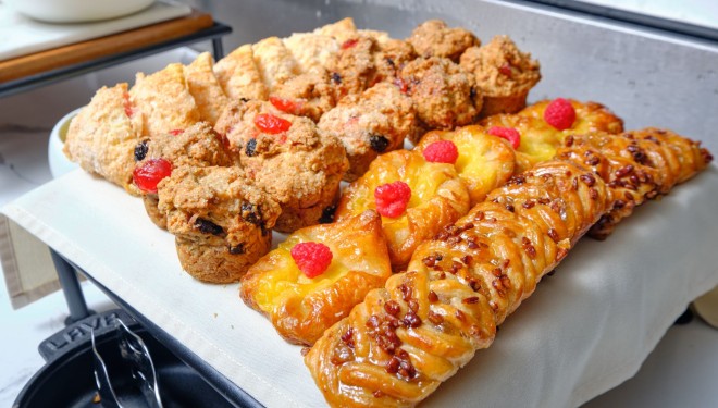 a tray of pastries and muffins