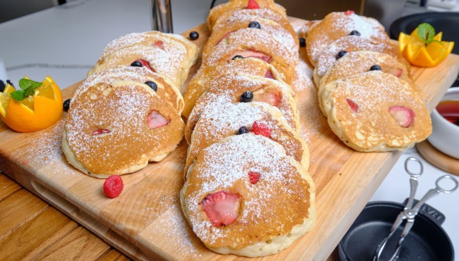 a group of pancakes with berries on top