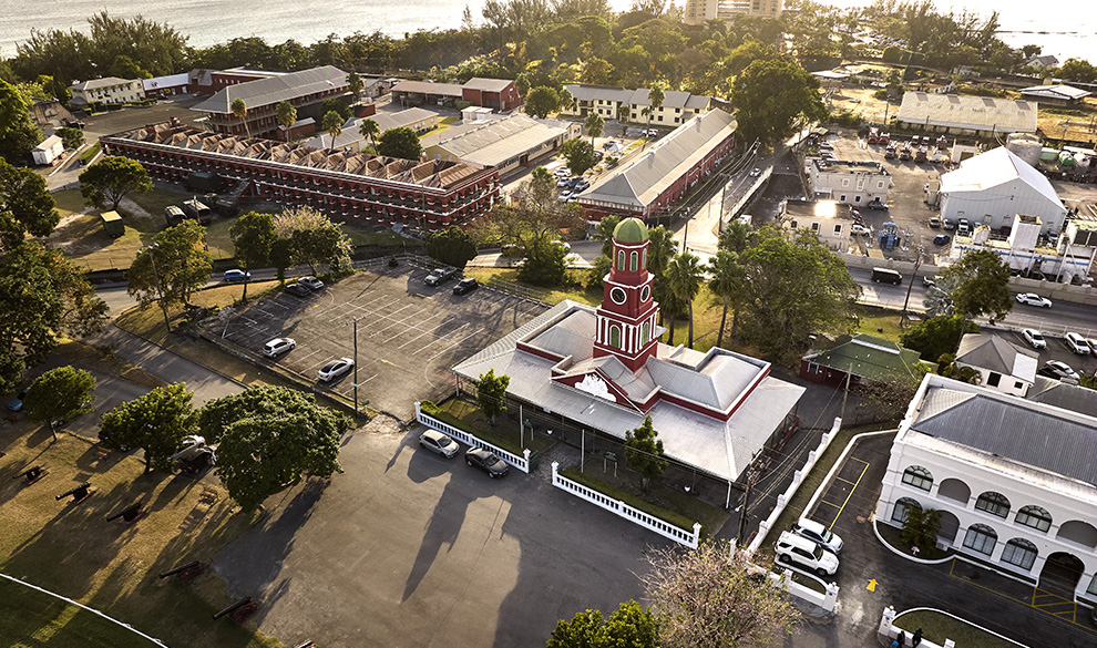 a building with a tower and a parking lot