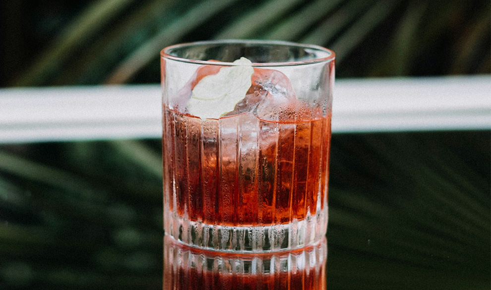 a glass with a drink and ice