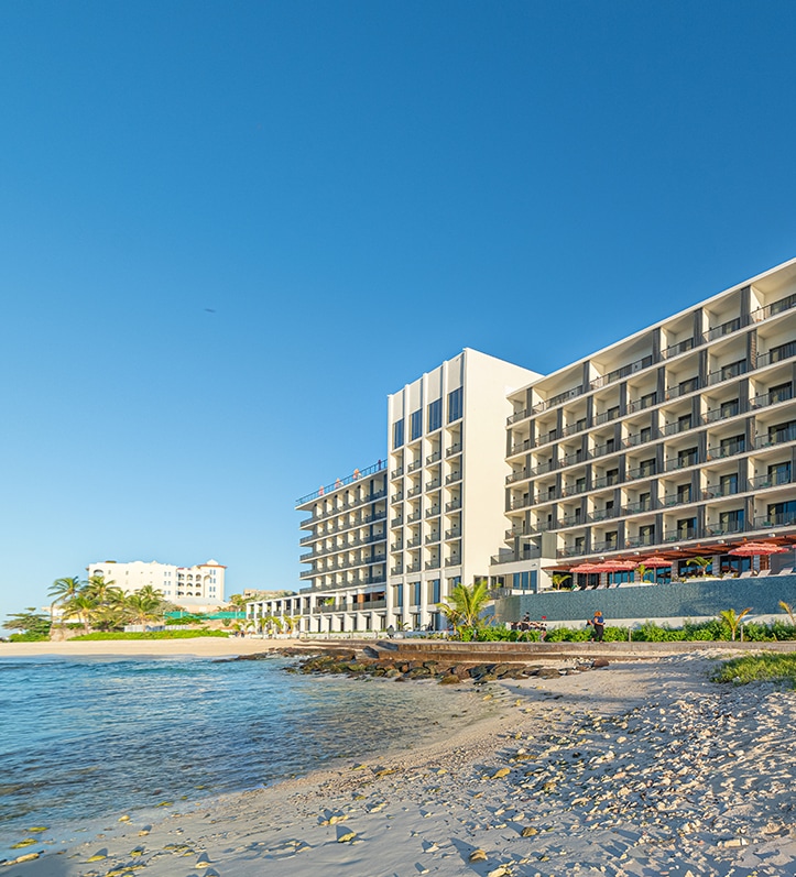 a large building next to a beach