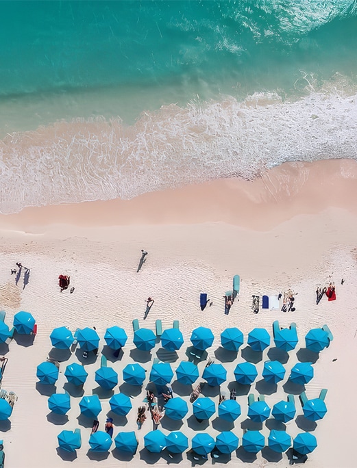 a beach with umbrellas and people on it