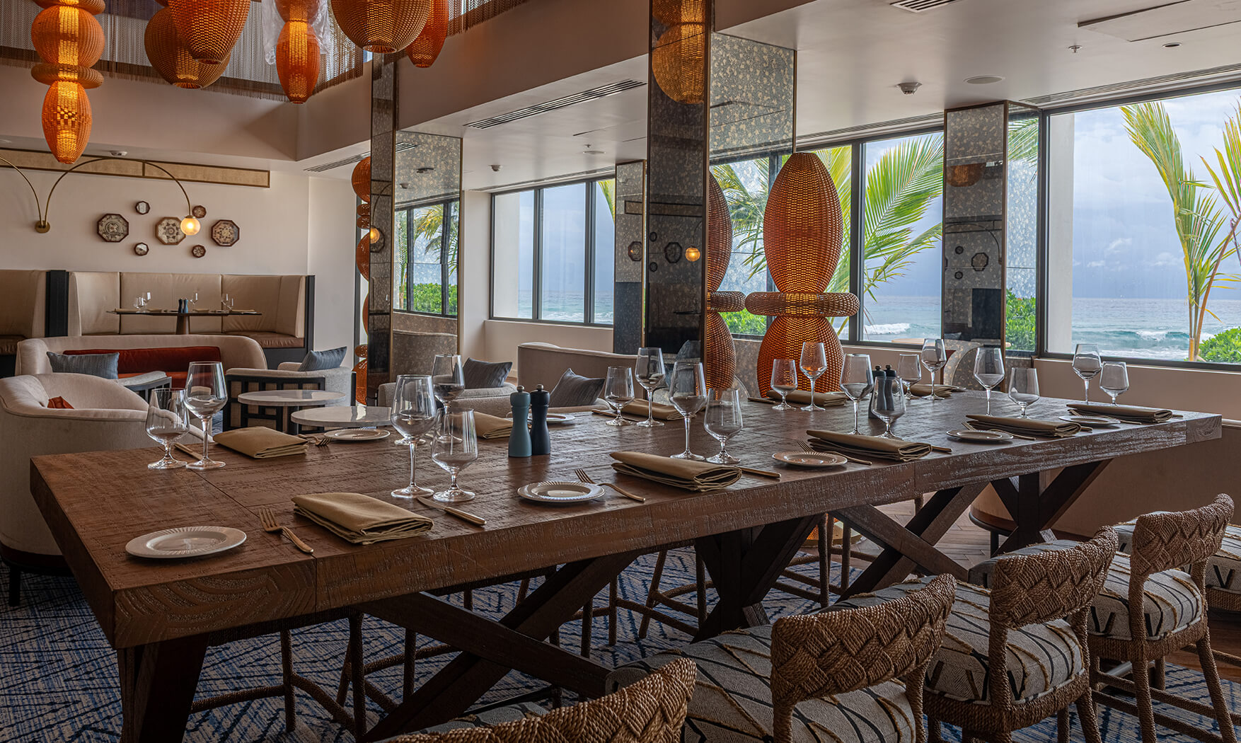 a large table with glasses and plates in a restaurant